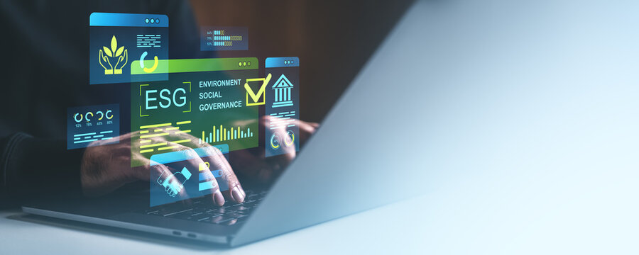 ESG digital concept with environmental, social, and governance metrics displayed as holograms over a laptop screen in a business context.