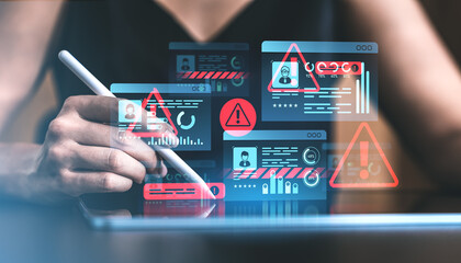 Cybersecurity warning displayed on digital interface with hand interacting on tablet.