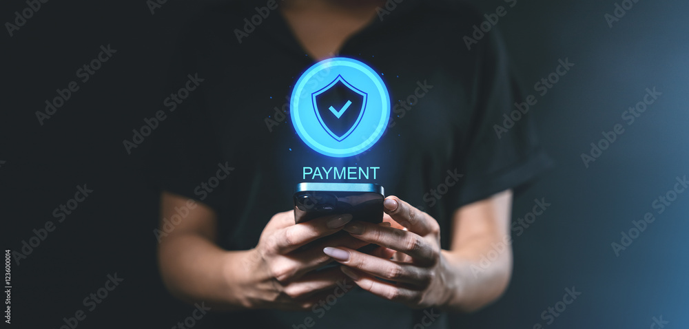 Aufkleber secure payment concept with glowing shield icon held above smartphone in hands of user.