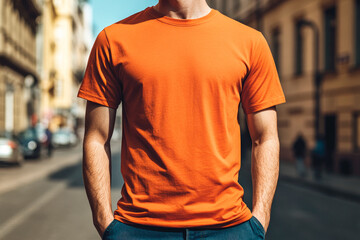 Man wearing orange t-shirt. Summer City Background. Mockup, copy space.