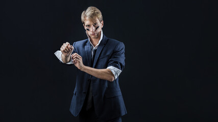 In a dimly lit studio, a man in a navy suit adopts a boxing stance, showcasing strength and...