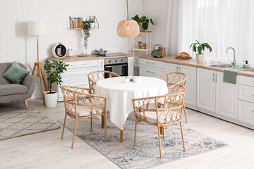 Interior of kitchen with white counters and dining table
