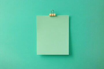Attention-grabbing blank green note with a push pin on white backdrop for office and school projects
