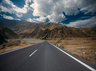 A long road with a mountain in the background