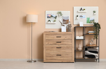 Beautiful living room with shelving unit, chest of drawers, lamp and pegboard