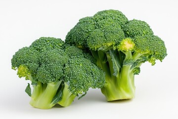 A bunch of fresh broccoli florets arranged on a clean white surface
