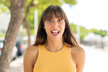 Young woman at outdoors with surprise facial expression