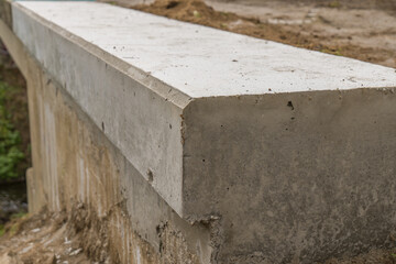 New concrete wall on the bridge. Reconstruction concept.