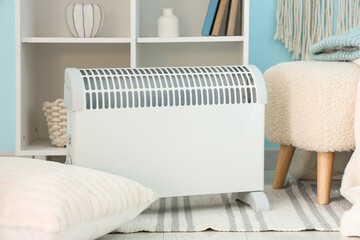Modern convector heater on floor in stylish living room, closeup