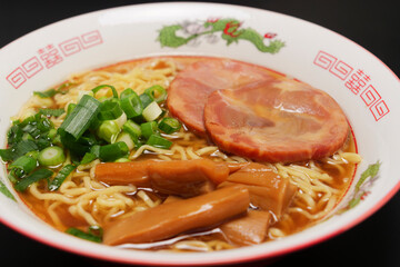 Soy sauce ramen noodles with grilled pork, bamboo shoots, and green onions, a noodle dish that has long been a favorite in Japan