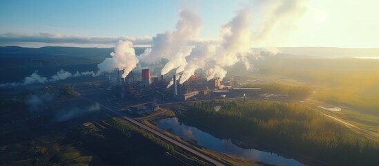 Industrial Facility with Smoke Plumes at Sunset