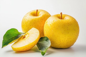 Fresh yellow apples with green leaves on a white background