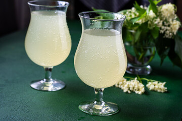 Carbonated elderflower drink. Flower summer kvass in glasses. Sparkling homemade hugo water. Cold beverage