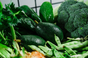 pile of green vegetables from the farm market fresh and clean, focus on avocado, green beans, broccoli