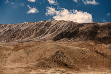 A mountain range with a clear blue sky in the background