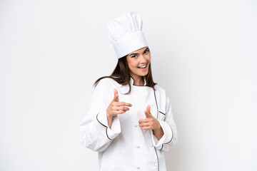 Young Brazilian chef woman isolated on white background pointing to the front and smiling