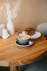 Coffee and cake on a wooden table in a cozy cafe during afternoon relaxation time