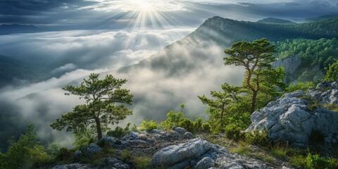 Obraz premium Sunlight breaks through clouds over mountainous terrain