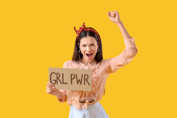 Young pin-up woman with GRL PWR sign on yellow background. Women's History Month