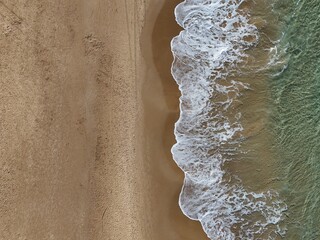 View of waves on a beach, 90 degrees down, bird's eye view