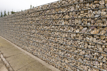 Gabion fence around a house