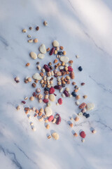 Mixed dried legumes: peas, lentils, beans, haricot, buckwheat, chickpea on white maarble background, Top view image.