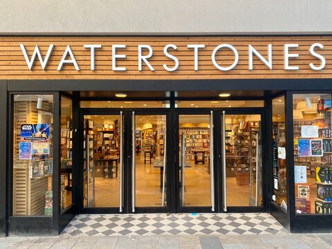 Bracknell, England - February 02, 2025: The lights are on in the window display of the Waterstones book shop.Front view from the outside.