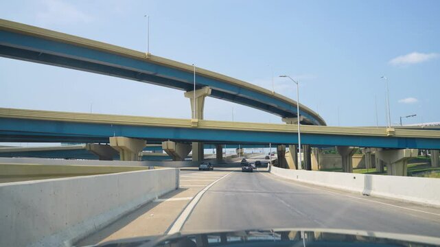 Car driving near an interstate junction on a clear day