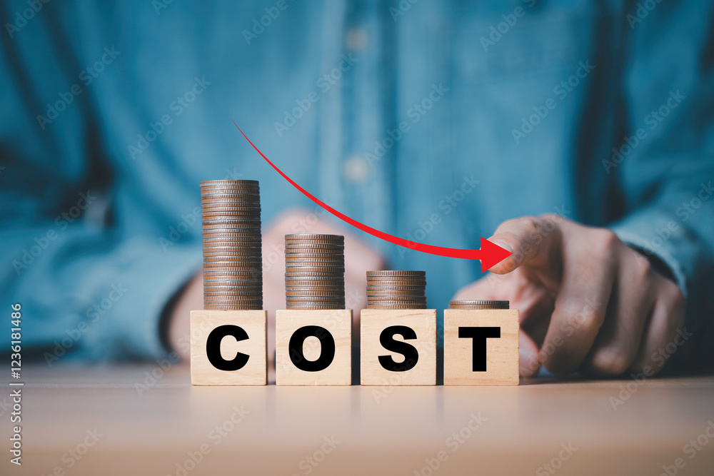 Poster businessman hand drawing down arrow with decreasing of coins stacking for cost reduction in factory 