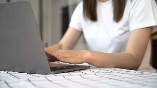 Female clicking internet search page on computer and smartphone touch screen at office