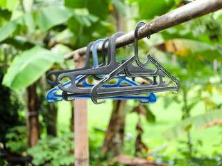 Old clothes hooks whose colors have faded are hung on dry bamboo