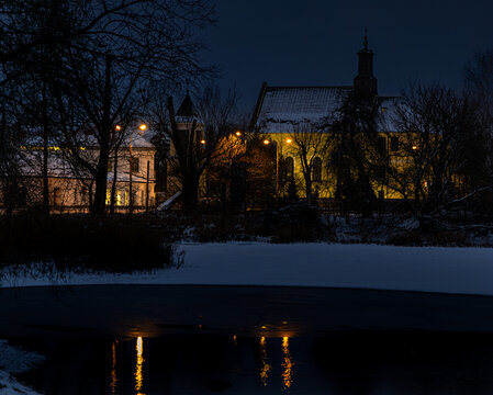 View of the church in Raszyn from the surrounding ponds, a quiet winter evening, Masovia, central Poland