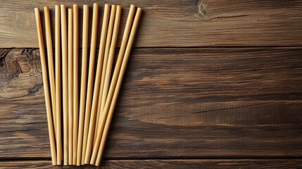 A set of eco-friendly bamboo straws arranged on a wooden table.