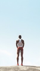 A person in an athlete is uniform, standing ready for the race, blank space behind