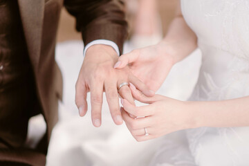 Wedding engagement rings. Bride put a wedding ring on finger of her groom at a wedding ceremony. Close-up. Newlyweds. Vow Ceremony