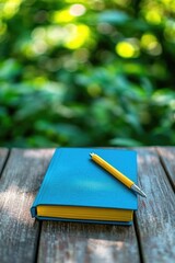 Blue notebook with yellow pencil