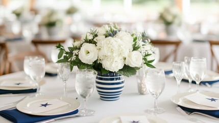 Fototapeta premium Elegant patriotic themed wedding table setting with a beautiful floral centerpiece in a blue and white striped vase set with red white and blue tableware celebrating Independence Day