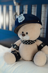 A toy teddy bear dressed in leather straps is a BDSM accessory for adult games in a police hat on...