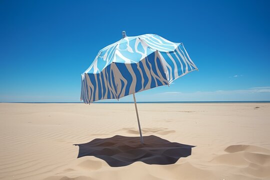 Vibrant beach umbrella casting shadow on a sunny beach, offering a welcome respite from the heat