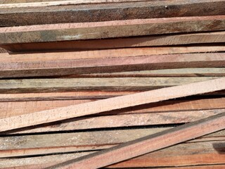 A pile of wooden blocks neatly stacked, displaying their natural texture and grain patterns. Captured using a straight-on angle