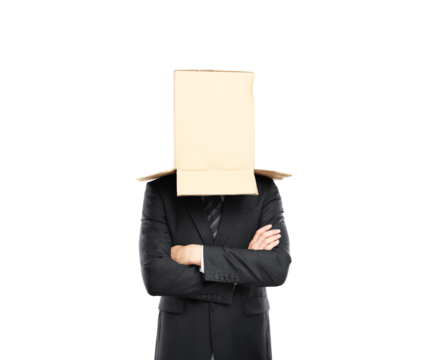 Businessman in a suit wearing a cardboard box on his head, arms crossed, isolated on a white background. Concept of anonymity or confusion - Powered by Adobe