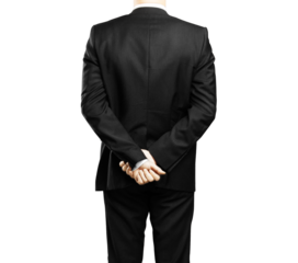 Rear view of a man in a formal suit standing with hands clasped behind his back, against an isolated white background. Concept of professionalism