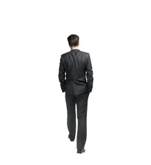 A man in a formal suit walking away with hands in pockets, isolated on a white background. Professional, business, or corporate concept