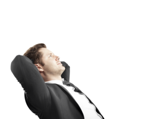 Relaxed businessman in a suit leaning back with hands behind his head, looking upward. Isolated on white background. Concept of confidence and success
