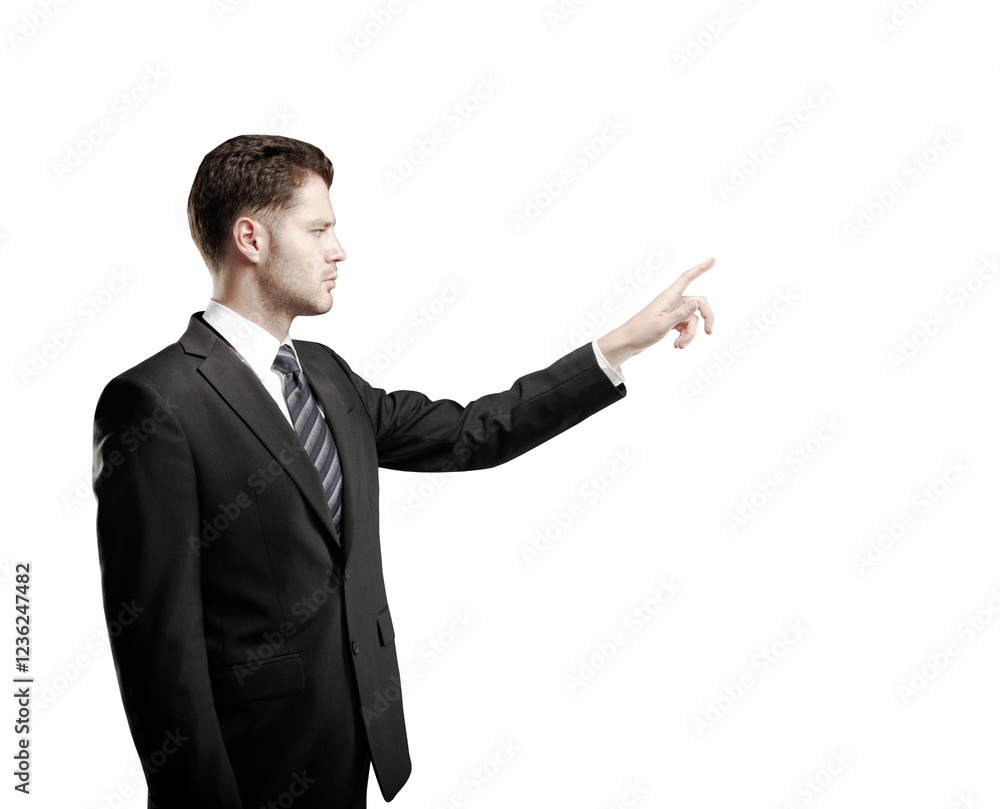 Poster Man in a suit pointing forward with a focused expression, isolated on a white background. Concept of business, direction, and decision-making