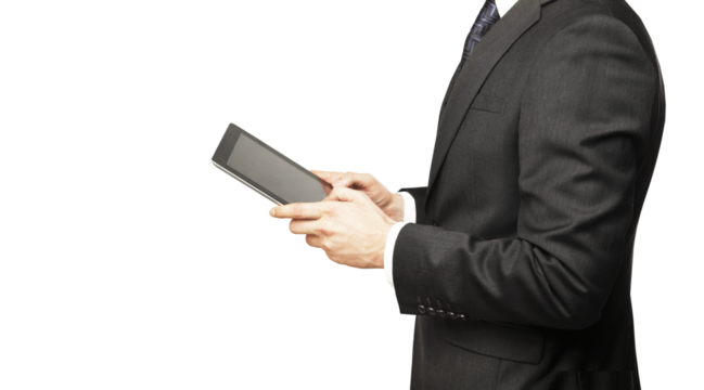 A businessman in a formal suit holding and using a tablet device, isolated on a white background. Concept of technology and business communication