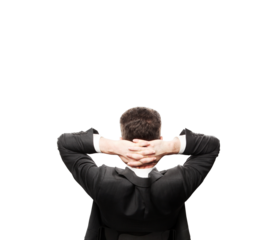 Man in asuit leaning back with hands clasped behind head, isolated on a clean white background. Concept of relaxation and confidence