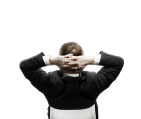 Rear view of a man in a suit leaning back with hands behind his head. Isolated on a white background. Concept of relaxation and confidence