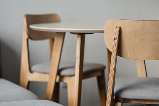 Plywood chair against the background of a table and a kitchen in defocus. Furniture and interior details of a modern.