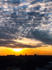 Sunset over the city silhouette